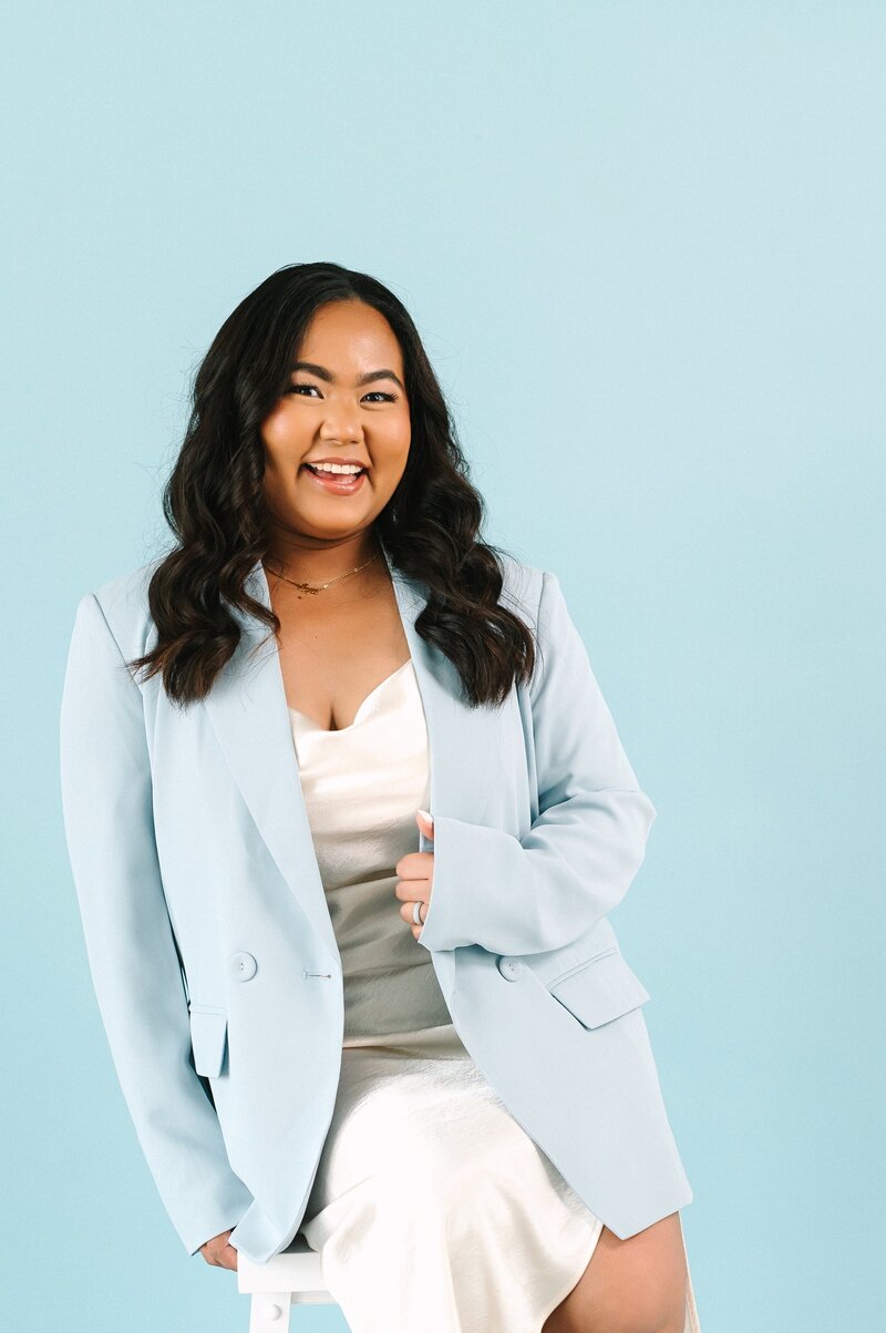 Picture of Lyn Smiling holding a photo of a couple