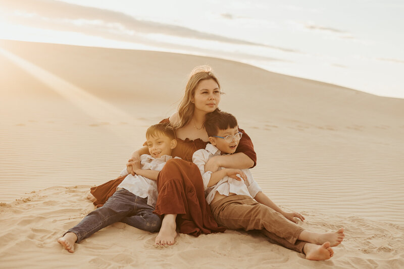 Corrina from Story Lens Photography with her twin boys in a field of flowers