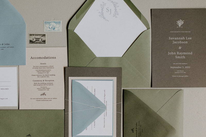 Brown wedding invitation with olive green and white envelopes