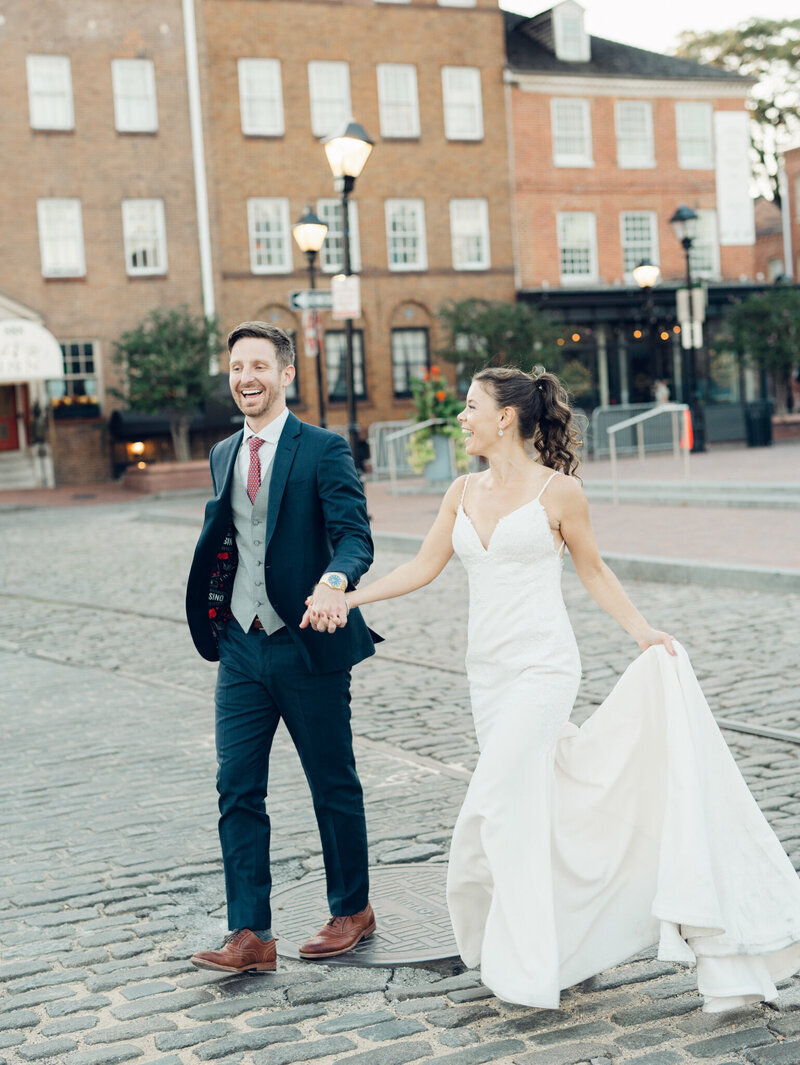 Bride and groom holding hands and walking across street, by dc film wedding photographer