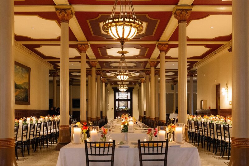 Elegant long-table wedding reception with candlelight in a historic Austin venue, planned for an upscale and welcoming celebration.