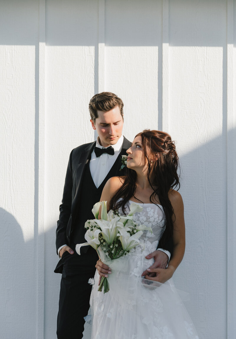 Styled shoot at Farmhouse on Green Bluff in Spokane WA. Couple in wedding attire, groom standing behind bride.
