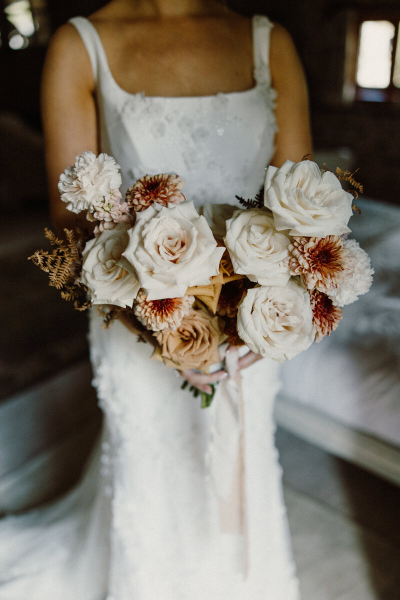 Bride holding stunning luxury wedding flowers designed by Bloominat