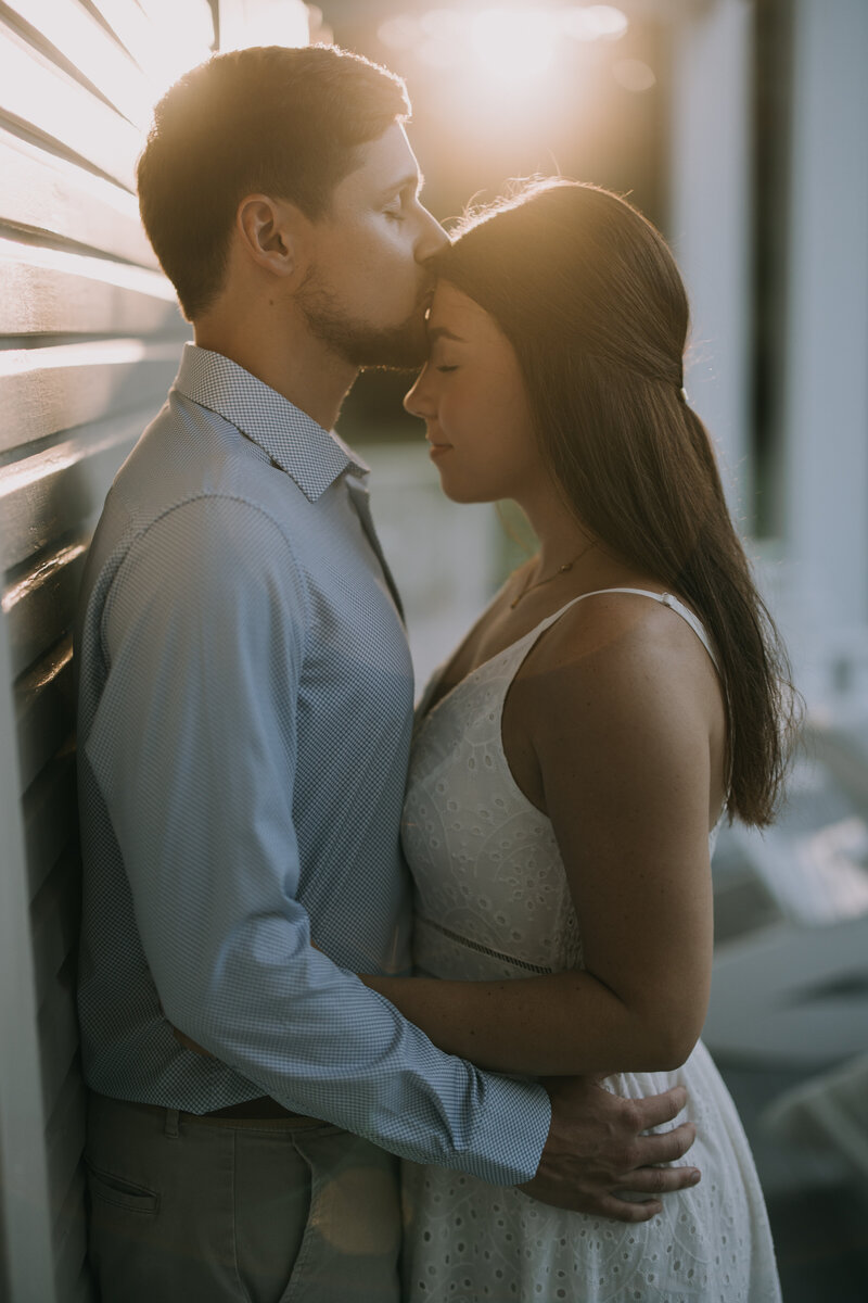 Couple embraces each other during their engagement photo session at sunset in Eden Gardens in Panama City, Florida.
