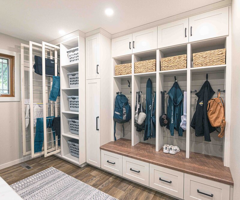 mudroom design with white wood and drying rack