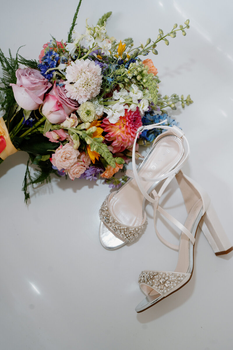 Bridal shoes are displayed by a portrait at Glenapp Castle wedding venue