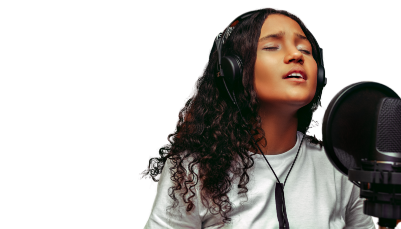 woman with her eyes closed singing into a microphone with headphones on
