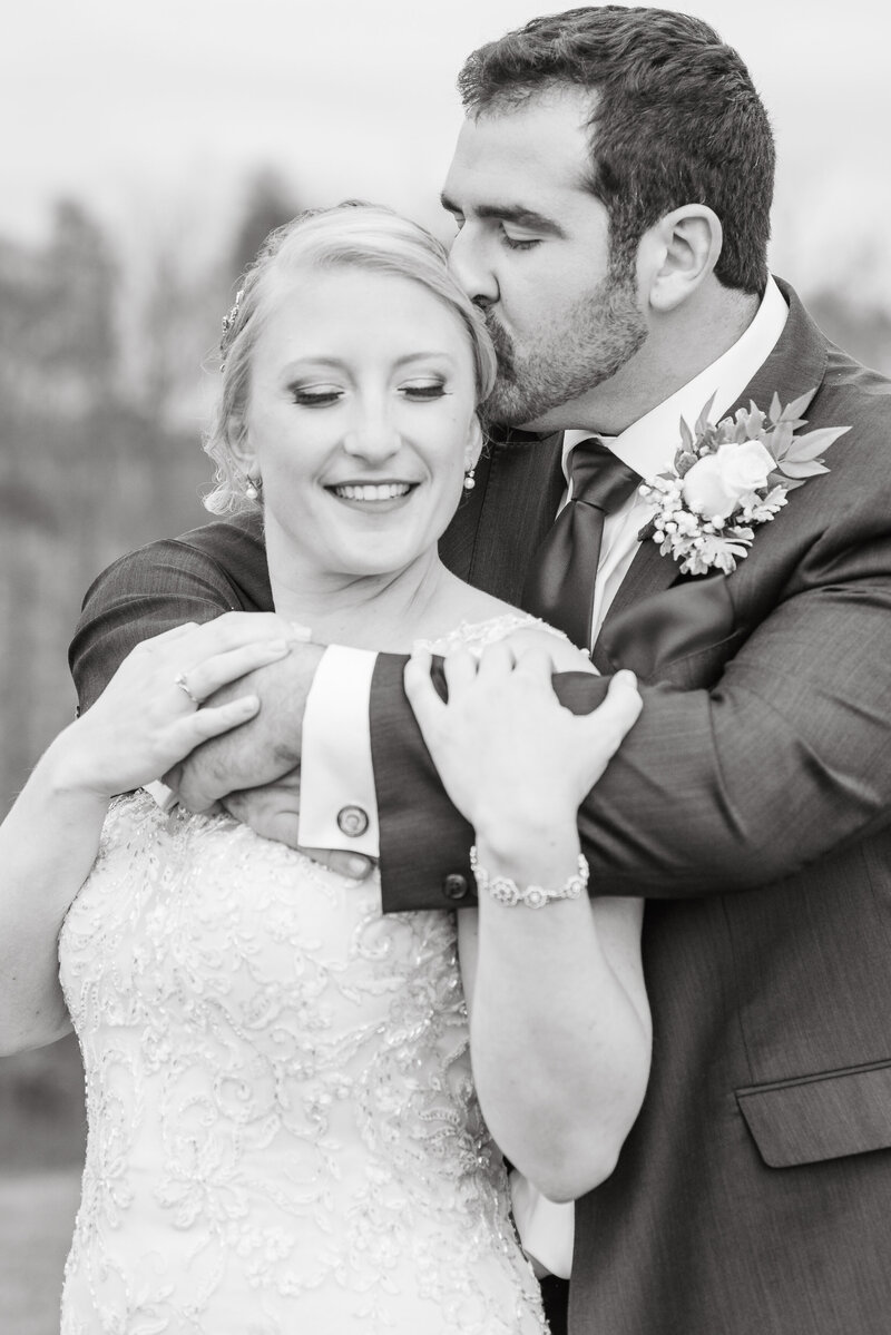 Bride and Groom  embracing in a black and white photo. - shot by Austin TX based Wedding Photographer Lydia Teague
