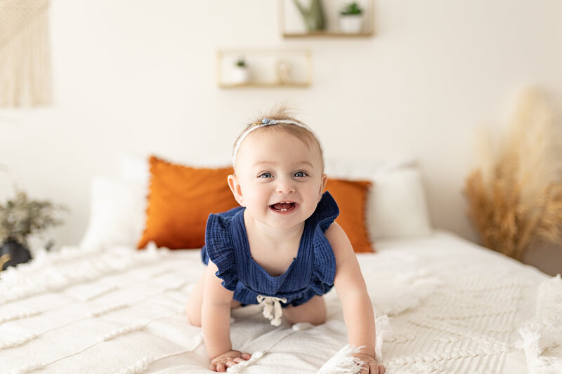 baby girl crawling on bed