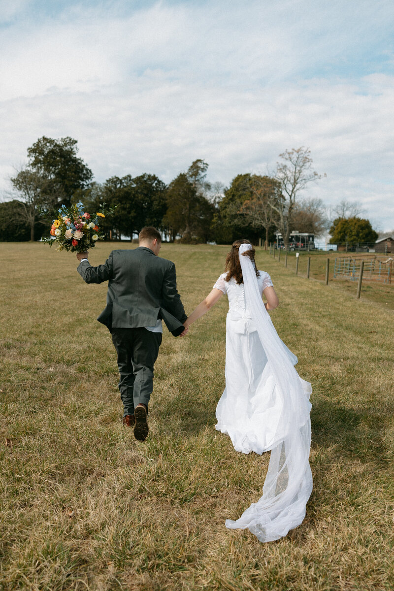 bride and groom running at Rural Hill Wedding Venue