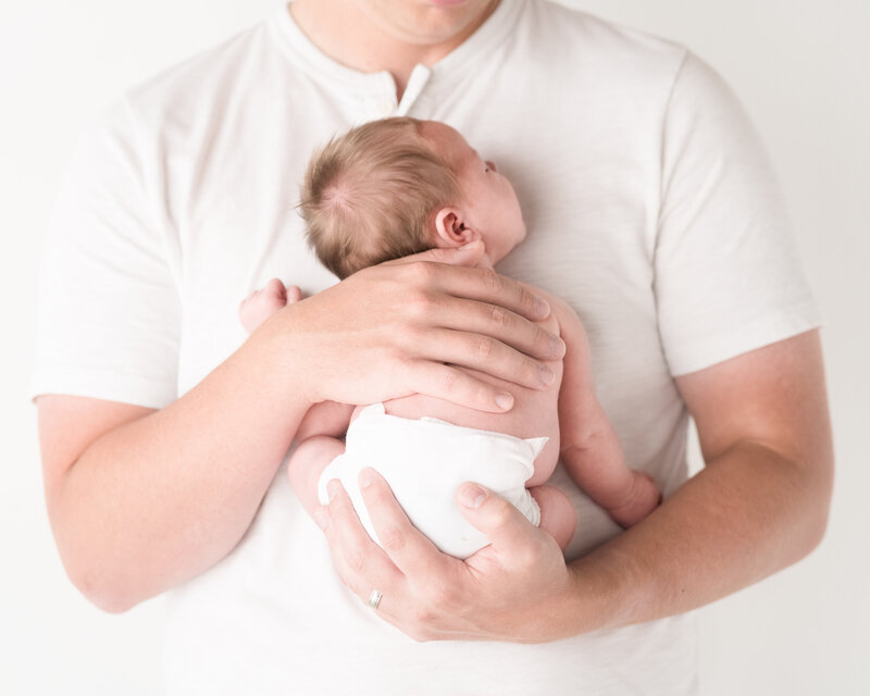 baby in dad's arms