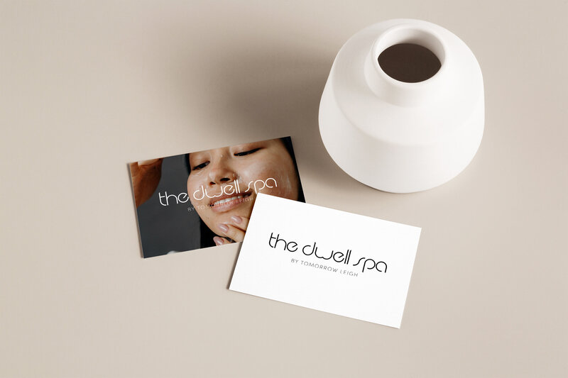 Business card mock-ups showing horizontal minimalist logo for The Dwell Spa.