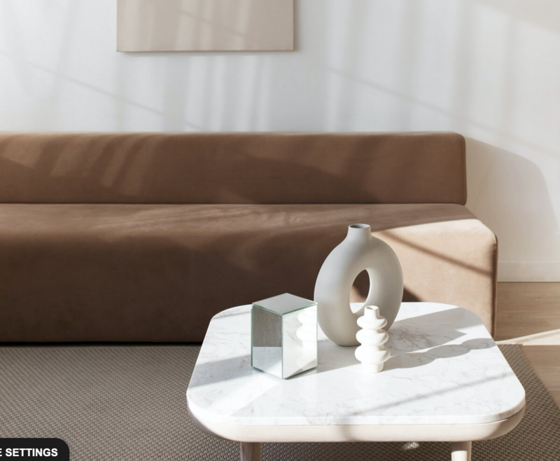 Brown coach, sun streaming in window, marble table