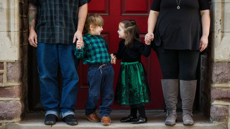 Boy and girl twins looking at each other and sharing a sweet sibling moment during a spring or autumn mini session in the Greater Phoenixville area.