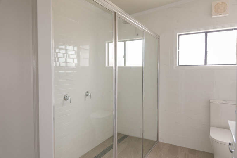 Contemporary bathroom showcasing sliding shower screens, combining functionality with a clean, modern design.