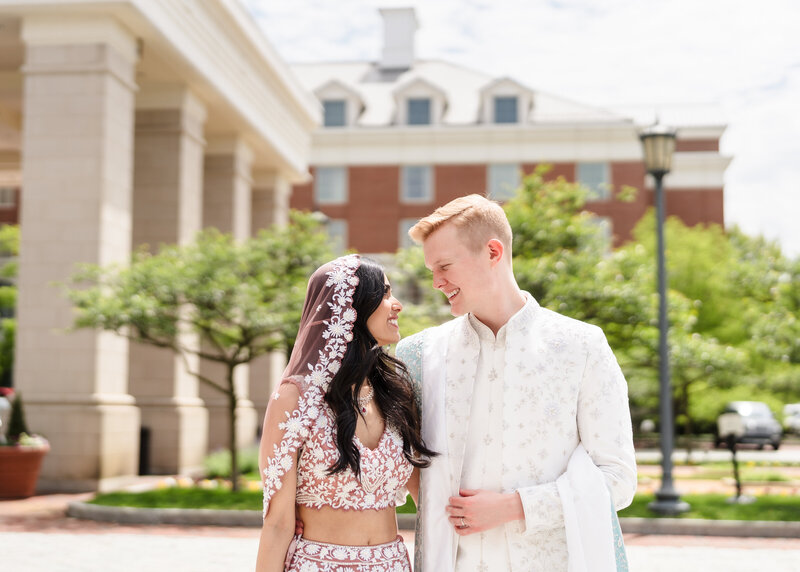 A bride and groom laugh as they exit their wedding ceremony