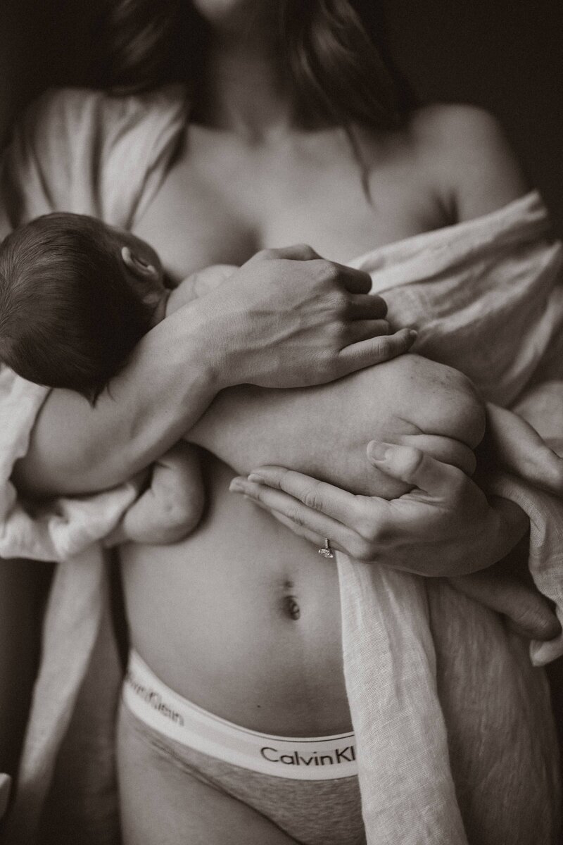 Mother holding newborn, empowered to use her voice as a thought leader