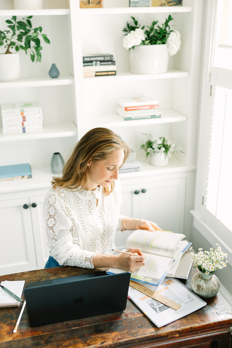 Small Business owner writing in her journal, part of a series of brand photographs by Lisa Scontras