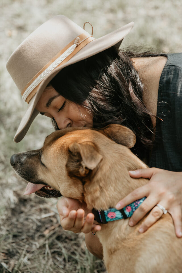 Montana Wolf of Montana Wolf Photography gives a hug and kiss to her dog