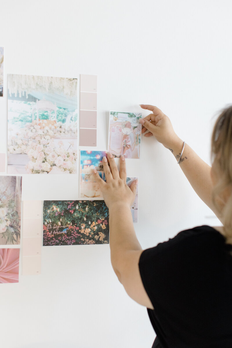 luxury sikh wedding planner smiling at her desk in front of her laptop