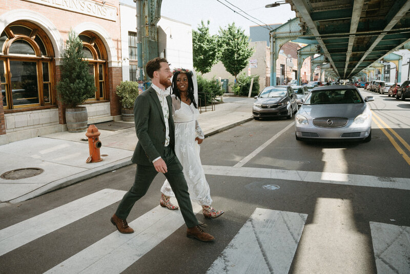 bride and groom walking around Philadelphia for wedding portraits