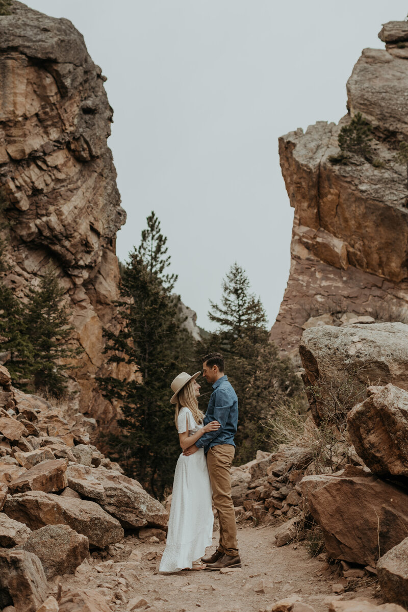 couple standing in the middle of a train in Eldorado Canyon State Park
