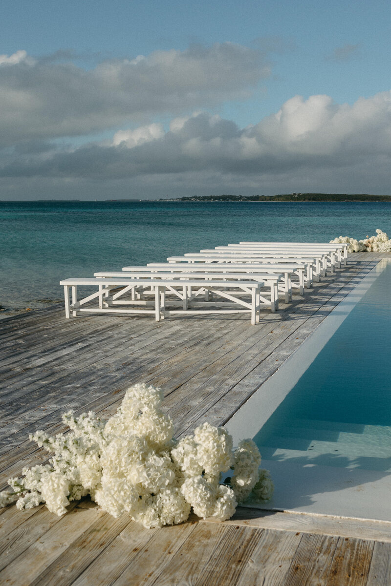 ceremony setup surrounding a pool with a ocean view 