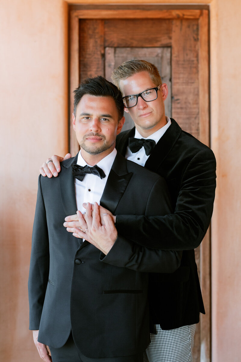 LGBTQIA couple embraces on their wedding day