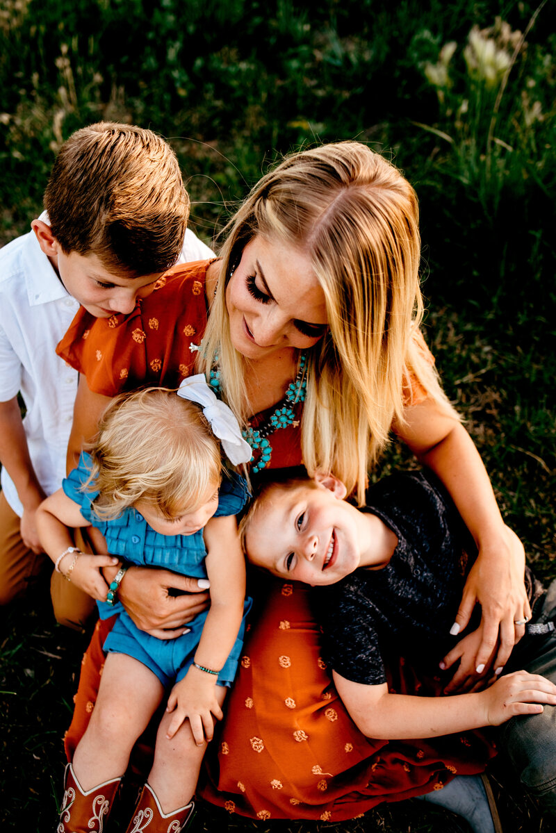 Mom and three kids dressed in boho clothes family pictures