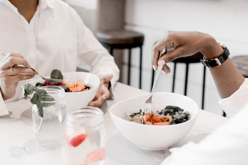 Photo of two people sharing a healthy meal during a 1:1 health coaching session. Say goodbye to feeling overwhelmed about your health. Discover the tools and options for sustaining your well-being through transformative personalized coaching. Take action with better choices and experience the power of change as you step towards a healthier, more vibrant you. Invest in yourself and embrace a renewed sense of vitality and direction. Start your journey towards optimal well-being today!