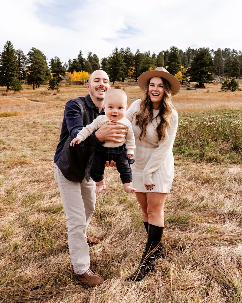 couple smiling with toddler son