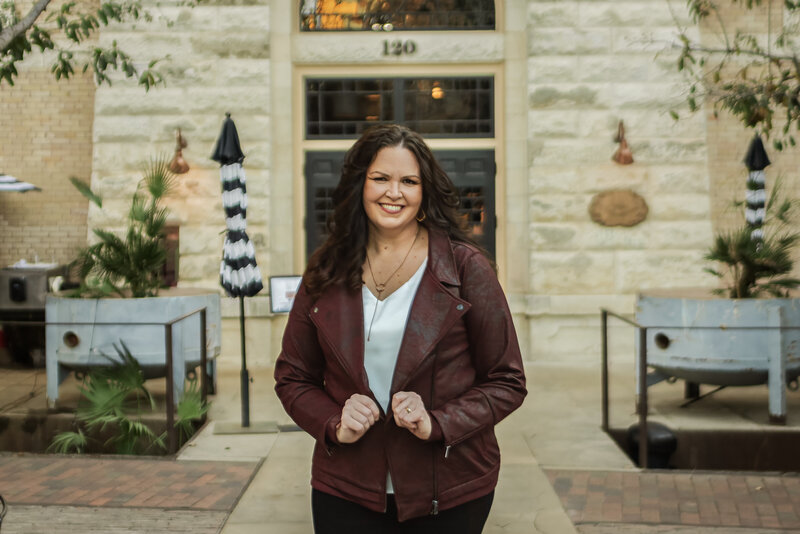 Jennifer Preiss, branding photographer, walking toward camera in downtown San Antonio