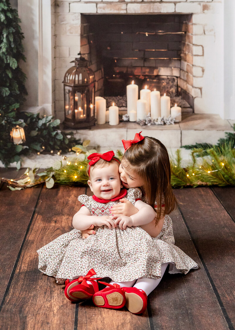 Holiday portrait of hugging siblings at Allison Reilly's Union County, NJ photo studio.