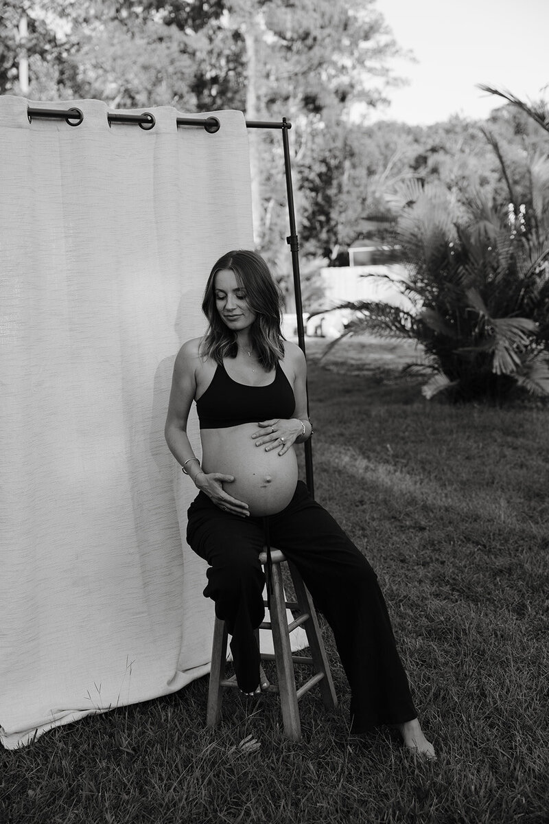 mom and her newborn baby snuggling on the window sill