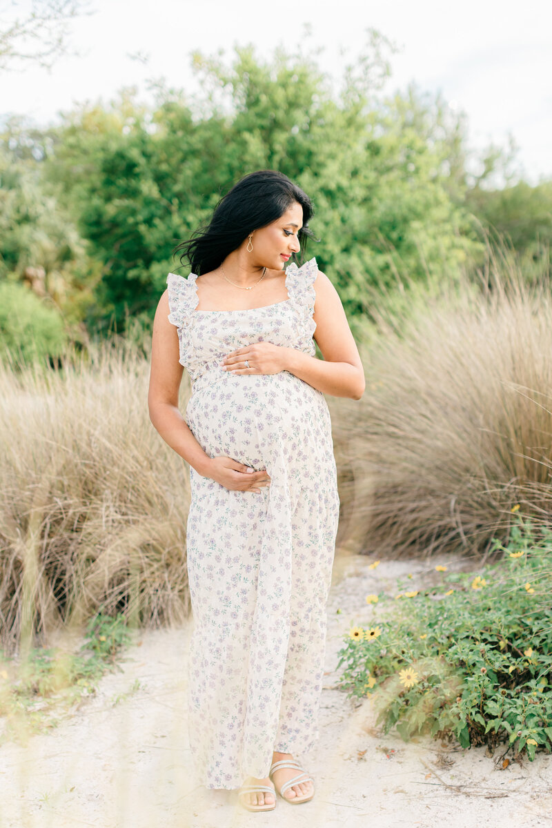 father to be embracing pregnant mother in tampa florida during maternity photography session