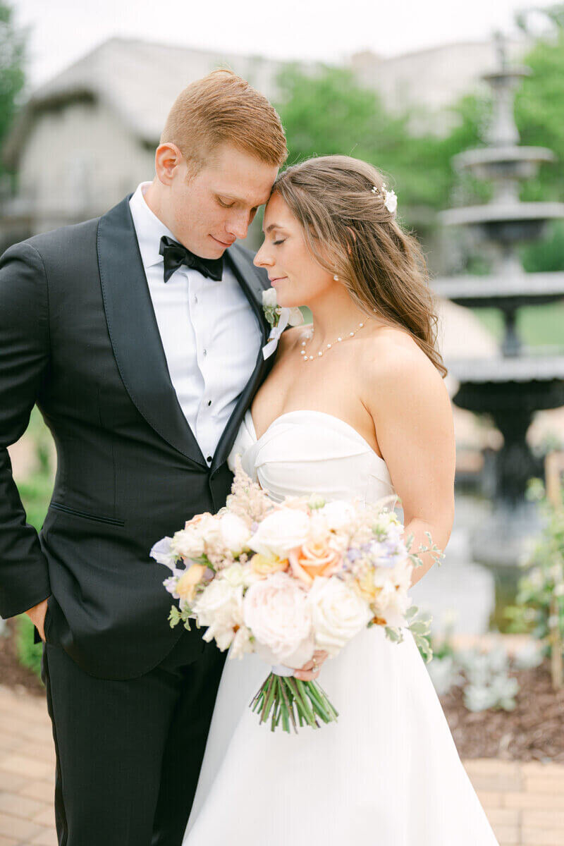 Bride and groom leaning against one another with eyes closed at wedding planned by event planners chicago