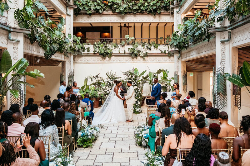 Wedding ceremony at the Fairchild House in Coconut Grove with the couple standing at the altar, photographed by Miami wedding photographer as part of the wedding day photo timeline.