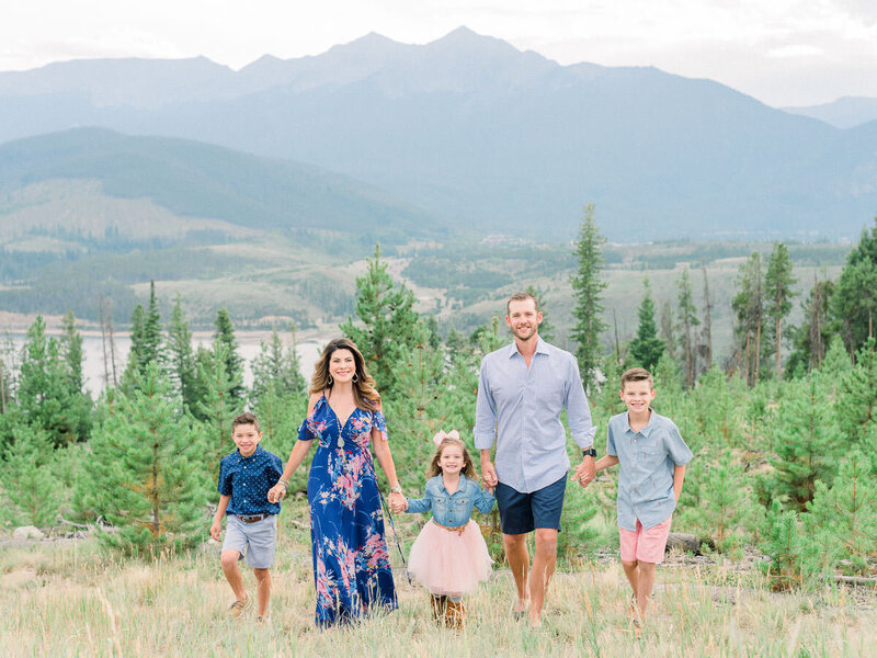 Family of 5 smiling during mountaintop family photoshoot on Lake Dillon