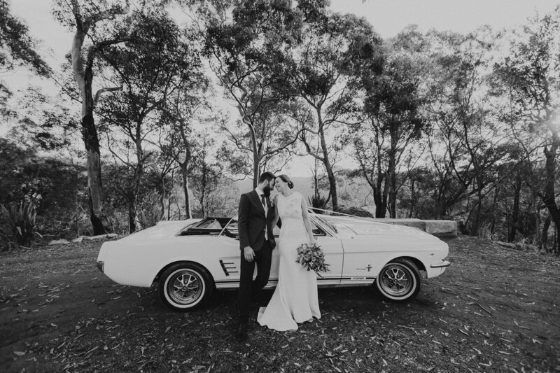 Black and white photograph of a Hunter Valley, Glenworth Valley wedding with a classic Mustang car
