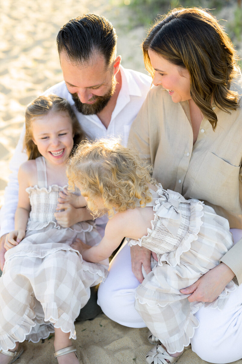 Family laughing together during Sydney beach family photoshoot 
