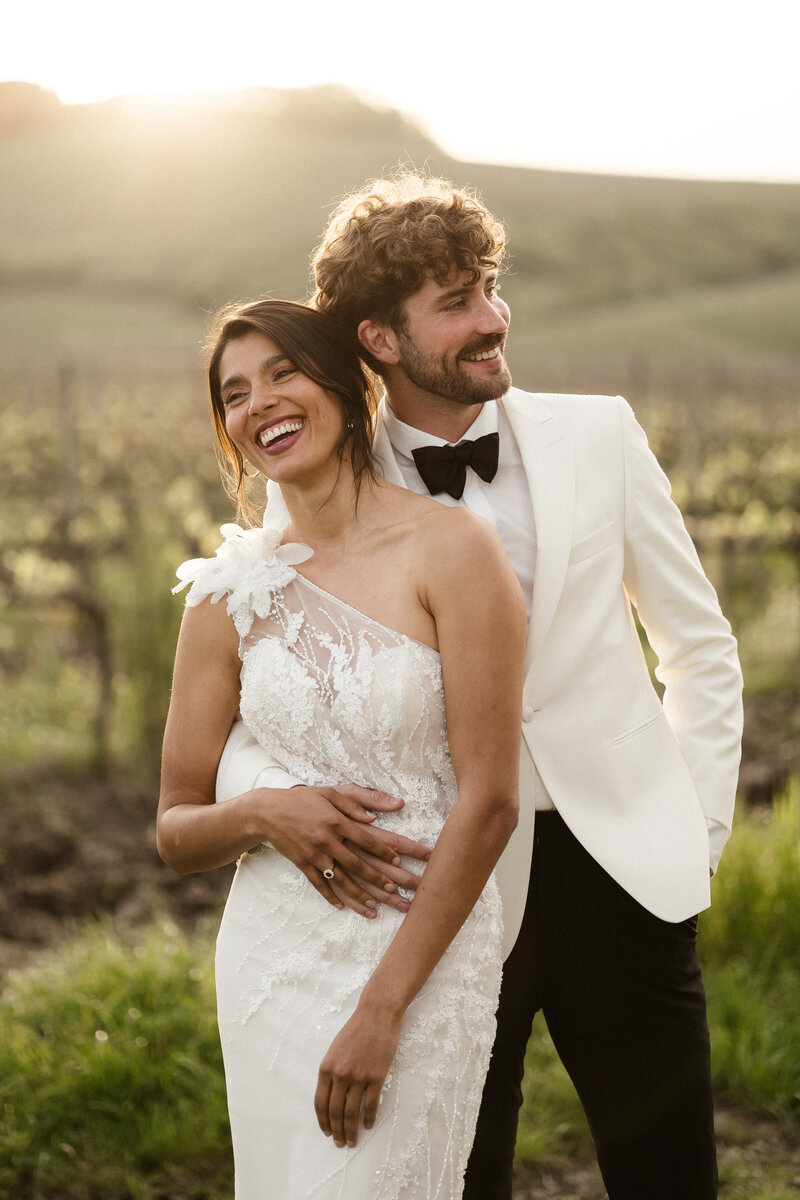 Wedding Couple during sunset in the midst of Vineyards in Tuscany in Italy.