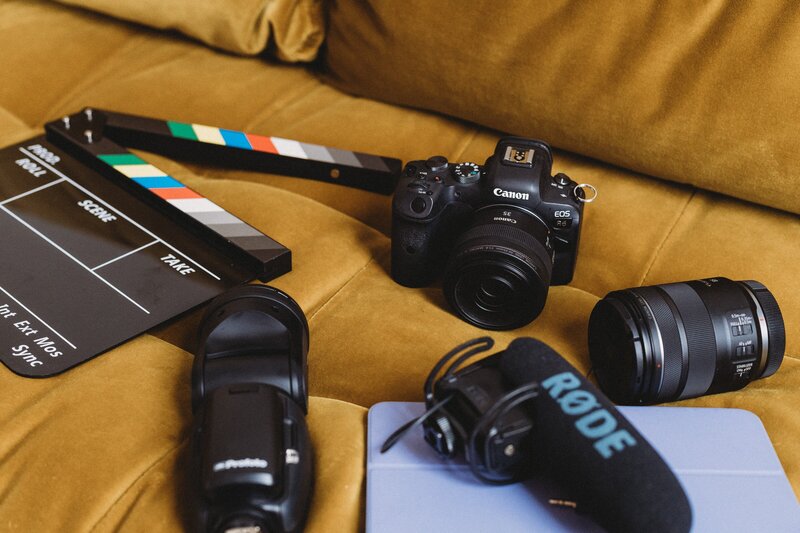 woman putting lenses into her camera bag