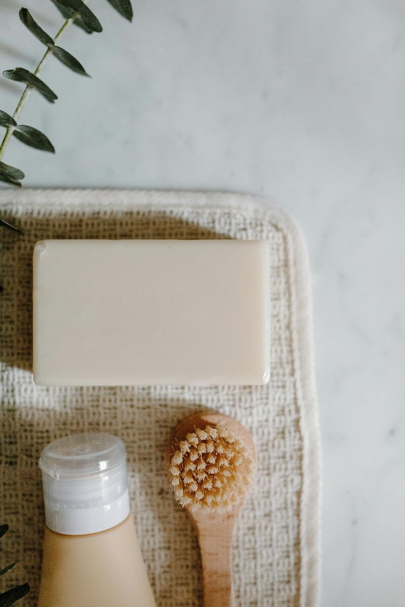 flat-lay of bath soap shower get bristle brush and eucalyptus