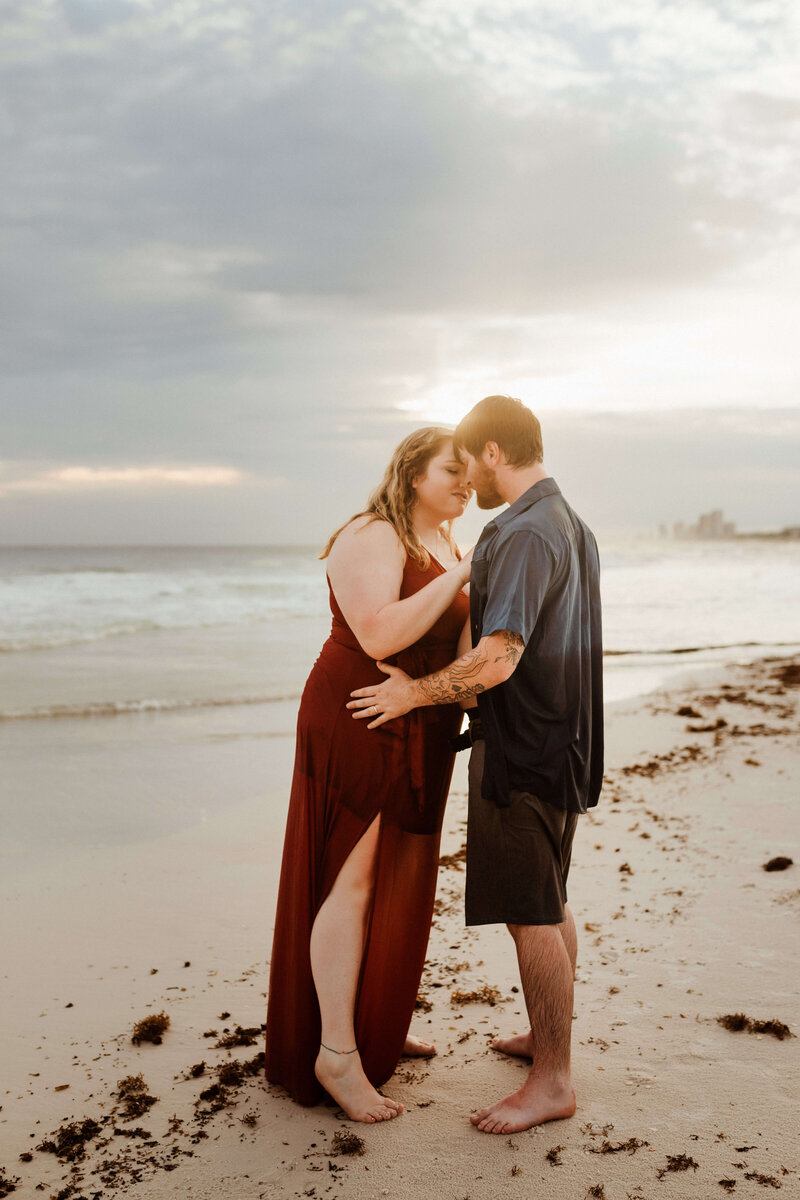 young couple on honeymoon in pcb - embracing on beach