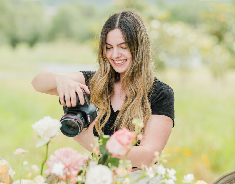 Liana Huot from Lia Rose Weddings is captured while photographing detail images of a bride and groom's wedding.