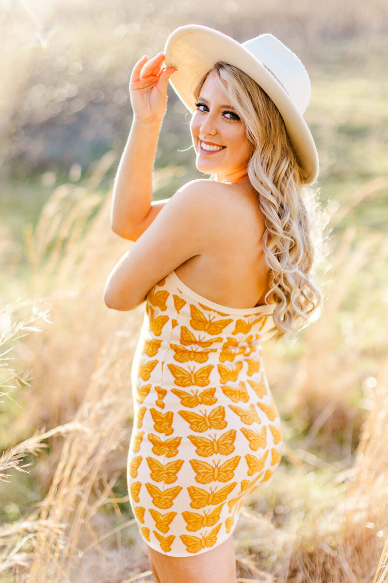 a girl in a sundress and hat
