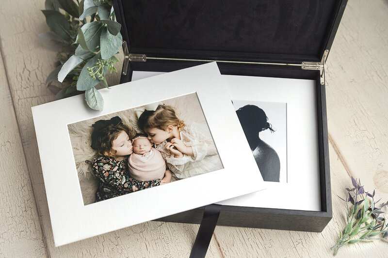 Newborn photos matted and stored in a luxury keepsake box