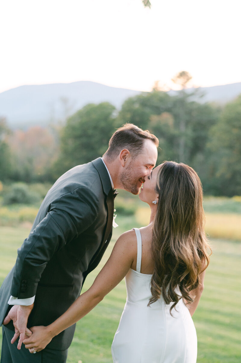 Couple kiss at sunset after their Hildene Wedding in Manchester Vermont.