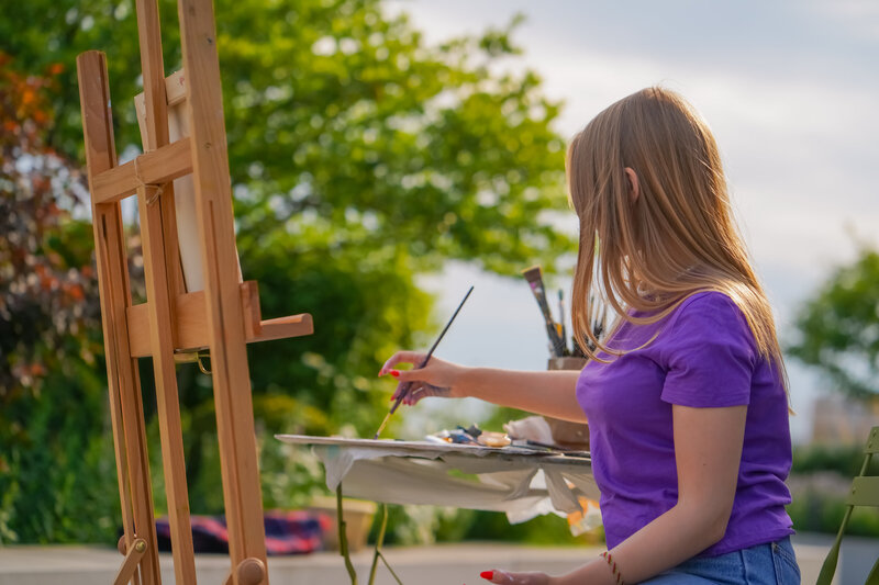 focused-girl-artist-with-paint-on-her-face-paintin-2024-01-02-19-30-32-utc