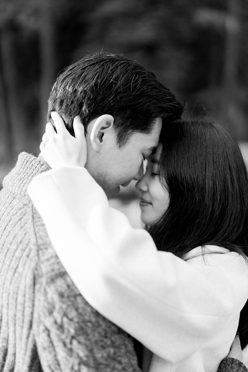 A tender moment captured during an engagement session at the Malibu Rocky Oaks Estate Vineyards in Malibu, California, photographed by Tiffany Longeway Photography.